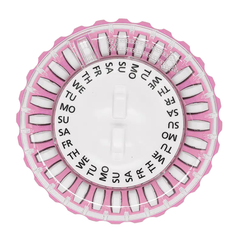 Round pink tablet dispenser with tablets labelled with days of the week